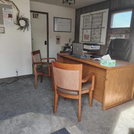 A spacious room with a wooden desk and chair.